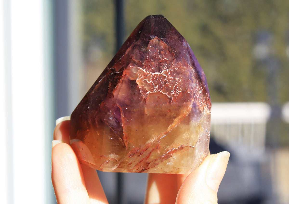 Red Dreamcoat Lemurian seed quartz tower with Super 7 inclusions and a Lemurian quartz core.