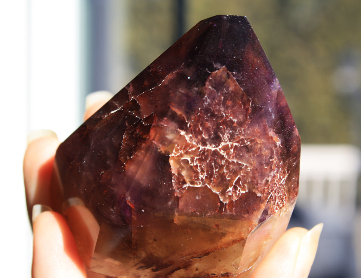 Red Dreamcoat Lemurian seed quartz tower with Super 7 inclusions and a Lemurian quartz core close up