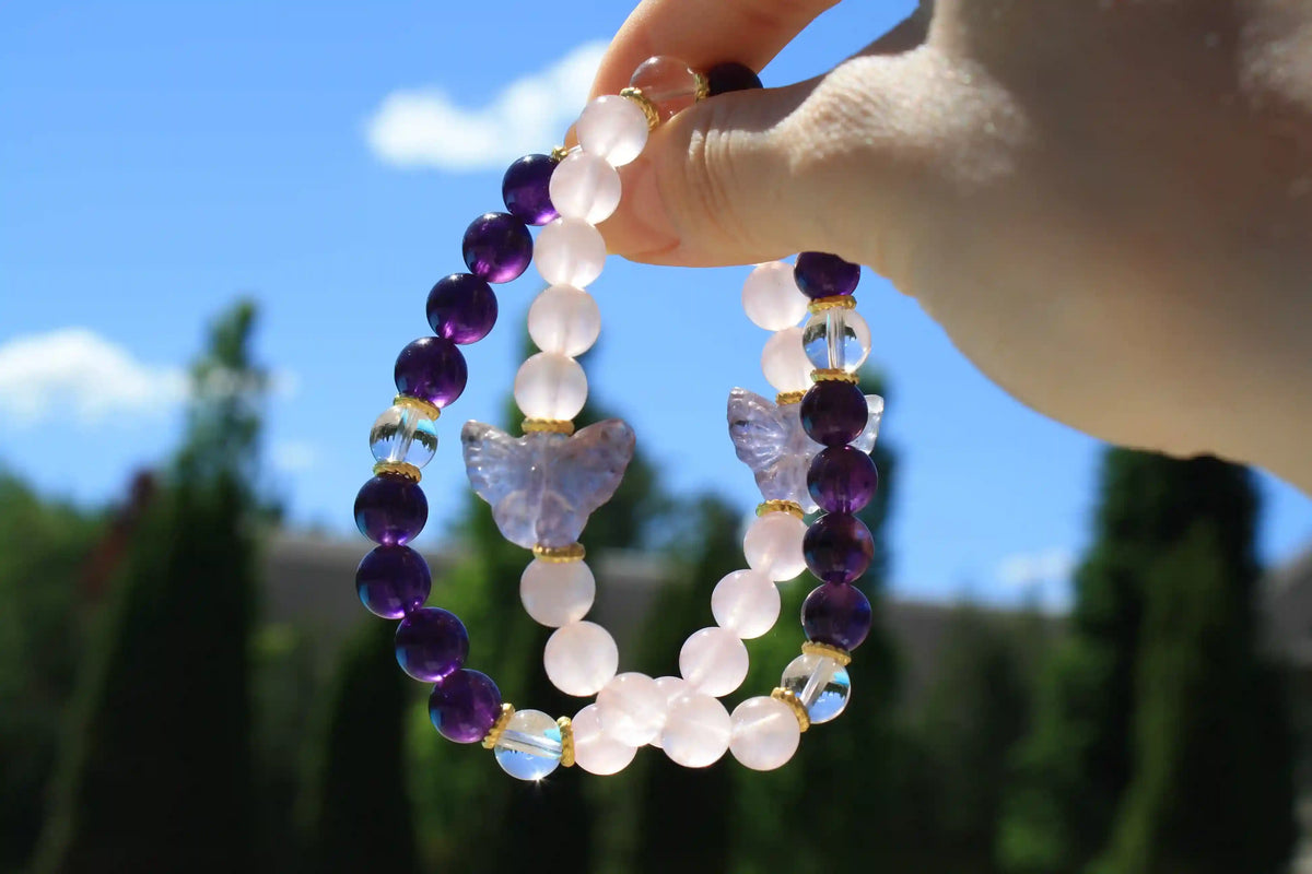 Beaded crystal bracelet with rose quartz and amethyst crystal and butterfly charms