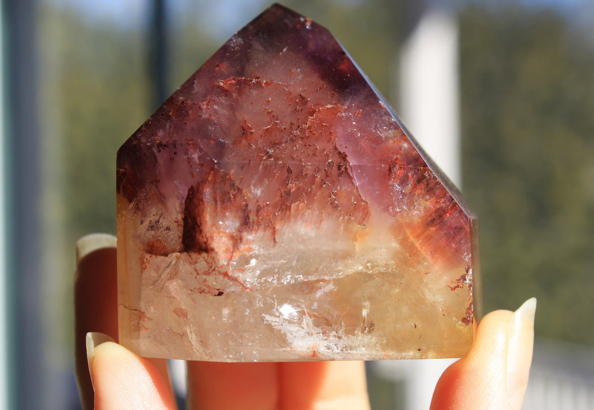 Red Dreamcoat Lemurian seed quartz tower with Super 7 inclusions and a Lemurian quartz core.