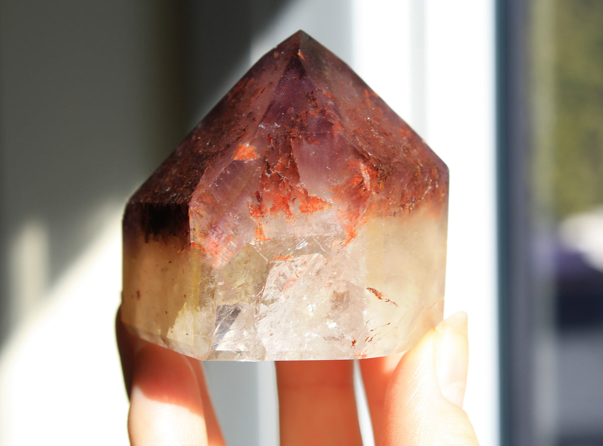 Red Dreamcoat Lemurian seed quartz tower with Super 7 inclusions and a Lemurian quartz core.