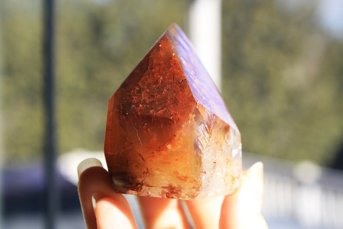 Red Dreamcoat Lemurian seed quartz tower with Super 7 inclusions and a Lemurian quartz core.