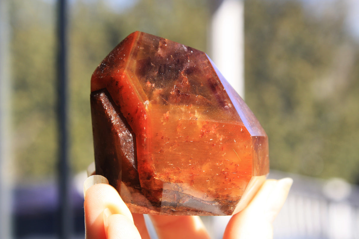 Red Dreamcoat Lemurian seed quartz tower with Super 7 inclusions and a Lemurian quartz core.