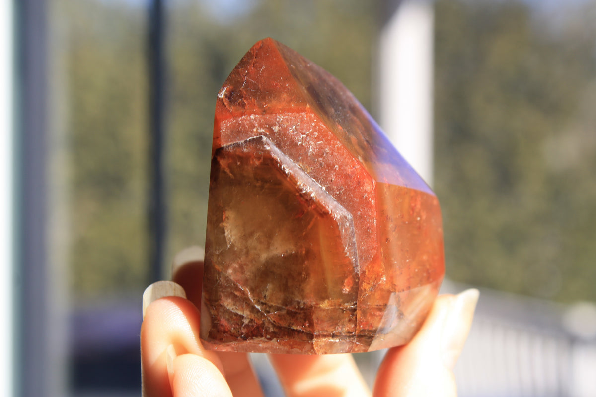 Red Dreamcoat Lemurian seed quartz tower with Super 7 inclusions and a Lemurian quartz core.