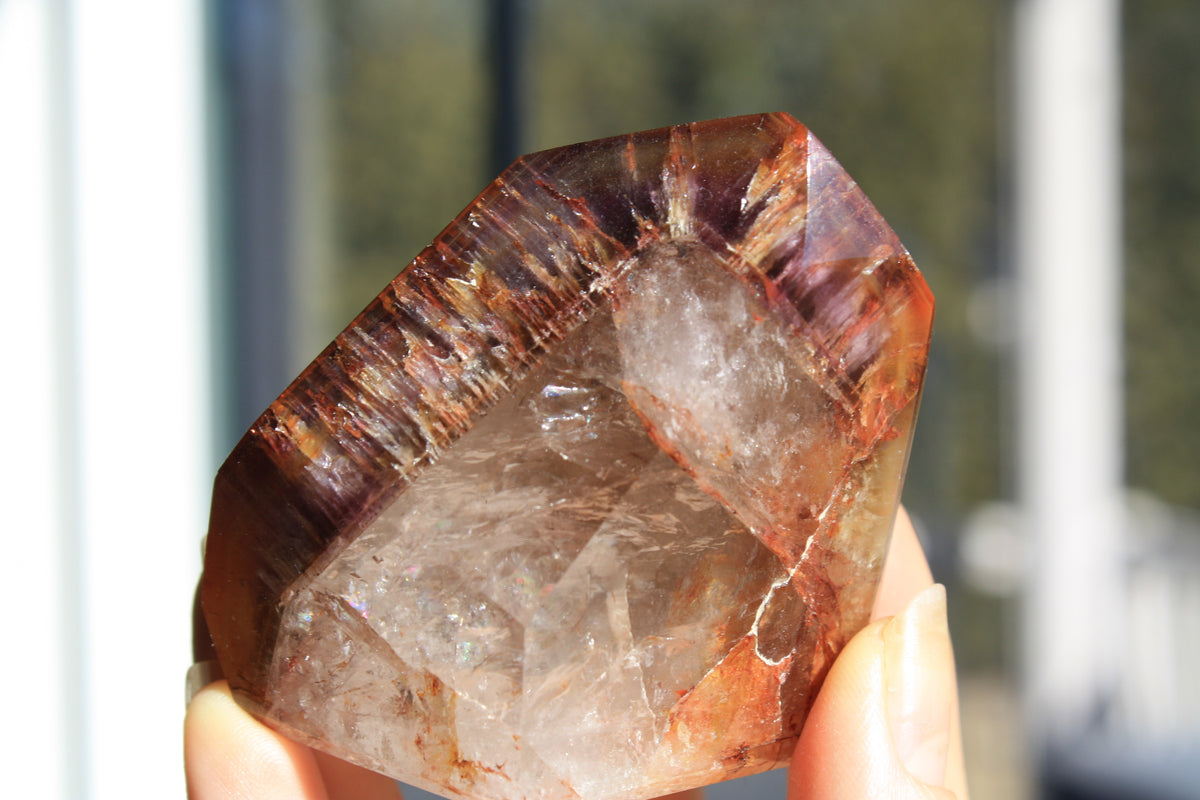 Red Dreamcoat Lemurian seed quartz tower with Super 7 inclusions and a Lemurian quartz core.