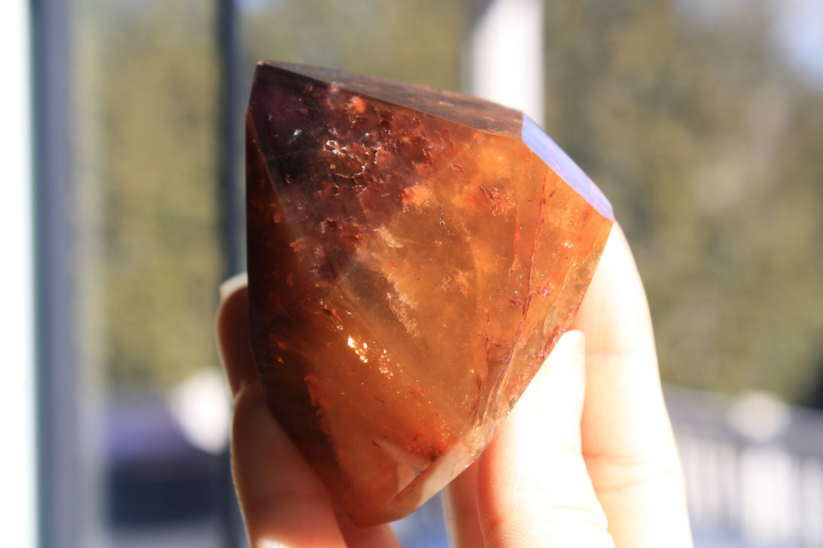 Red Dreamcoat Lemurian seed quartz tower with Super 7 inclusions and a Lemurian quartz core.
