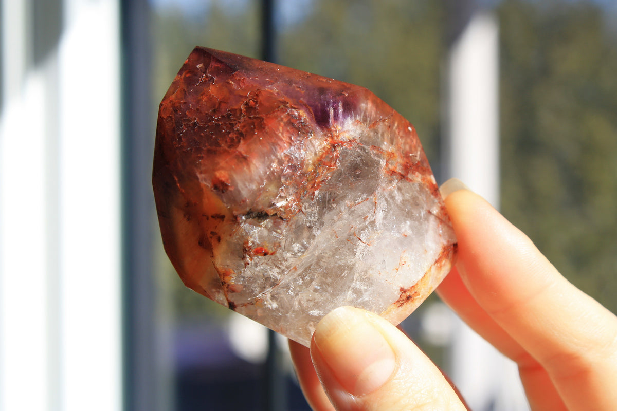 Red Dreamcoat Lemurian seed quartz tower with Super 7 inclusions and a Lemurian quartz core.