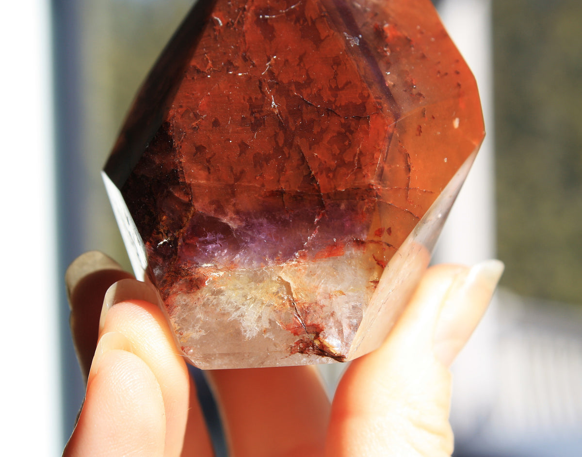 Red Dreamcoat Lemurian seed quartz tower with Super 7 inclusions and a Lemurian quartz core.