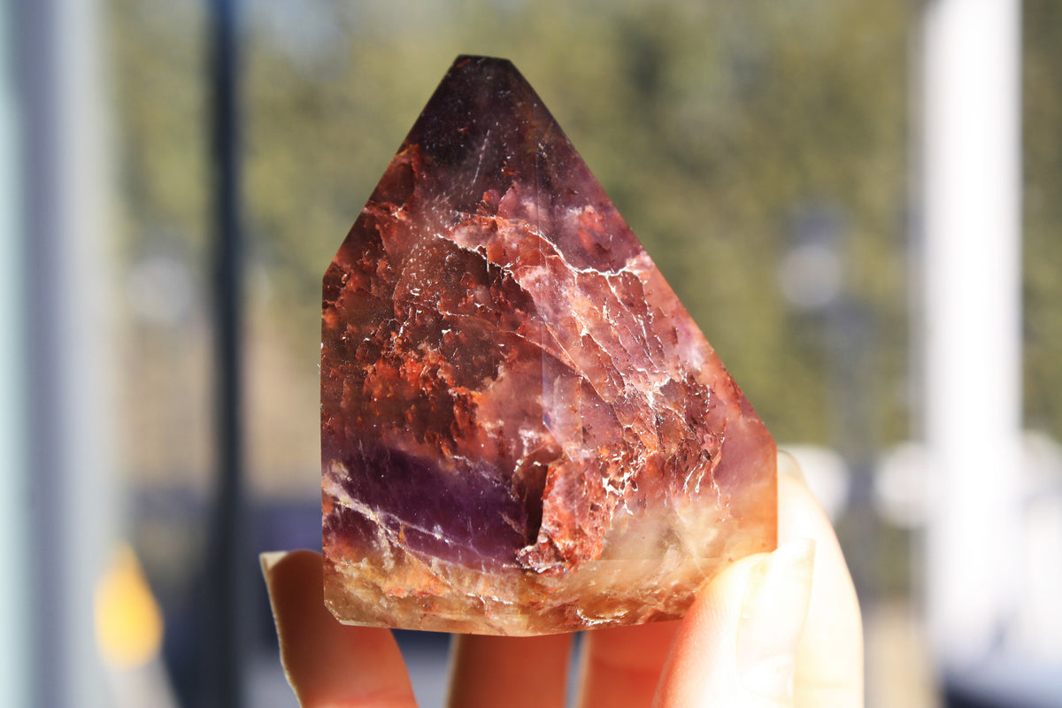 Red Dreamcoat Lemurian seed quartz tower with Super 7 inclusions and a Lemurian quartz core.