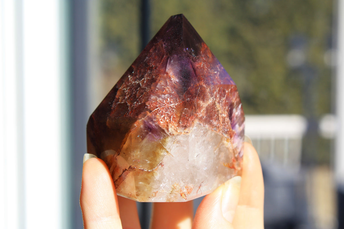 Red Dreamcoat Lemurian seed quartz tower with Super 7 inclusions and a Lemurian quartz core.