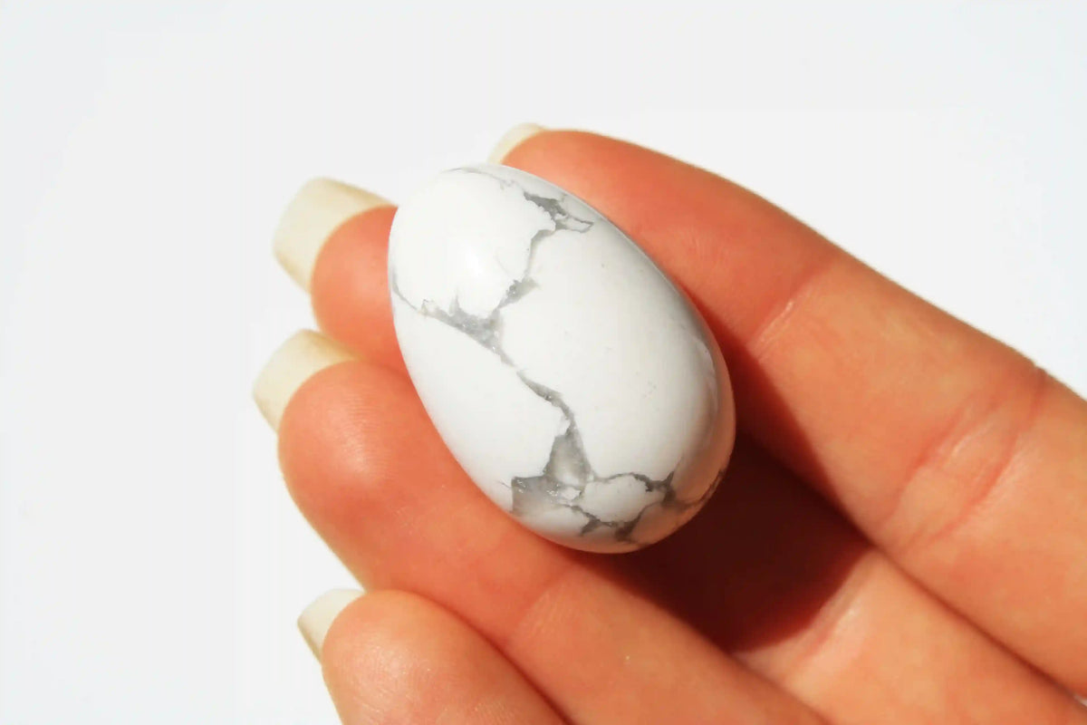 Howlite crystal egg-shaped stone with calming white tones and grey veining, symbolizing peace, clarity, and stress relief, howlite crystal, canadian crystal shop