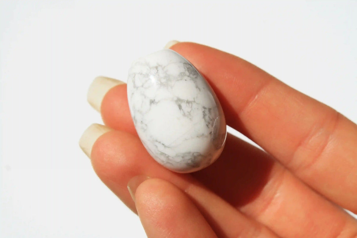 Howlite crystal egg-shaped stone with calming white tones and grey veining, symbolizing peace, clarity, and stress relief, howlite crystal, canadian crystal shop