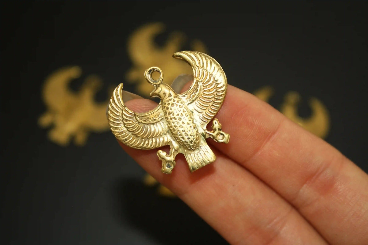 Egyptian falcon charm symbolizing protection, vision, and divine guidance, traditional amulet design, Egyptian symbols 
