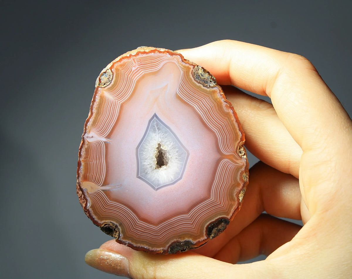 Large pink Zhanguo agate featuring natural banded patterns and a smooth polished finish
