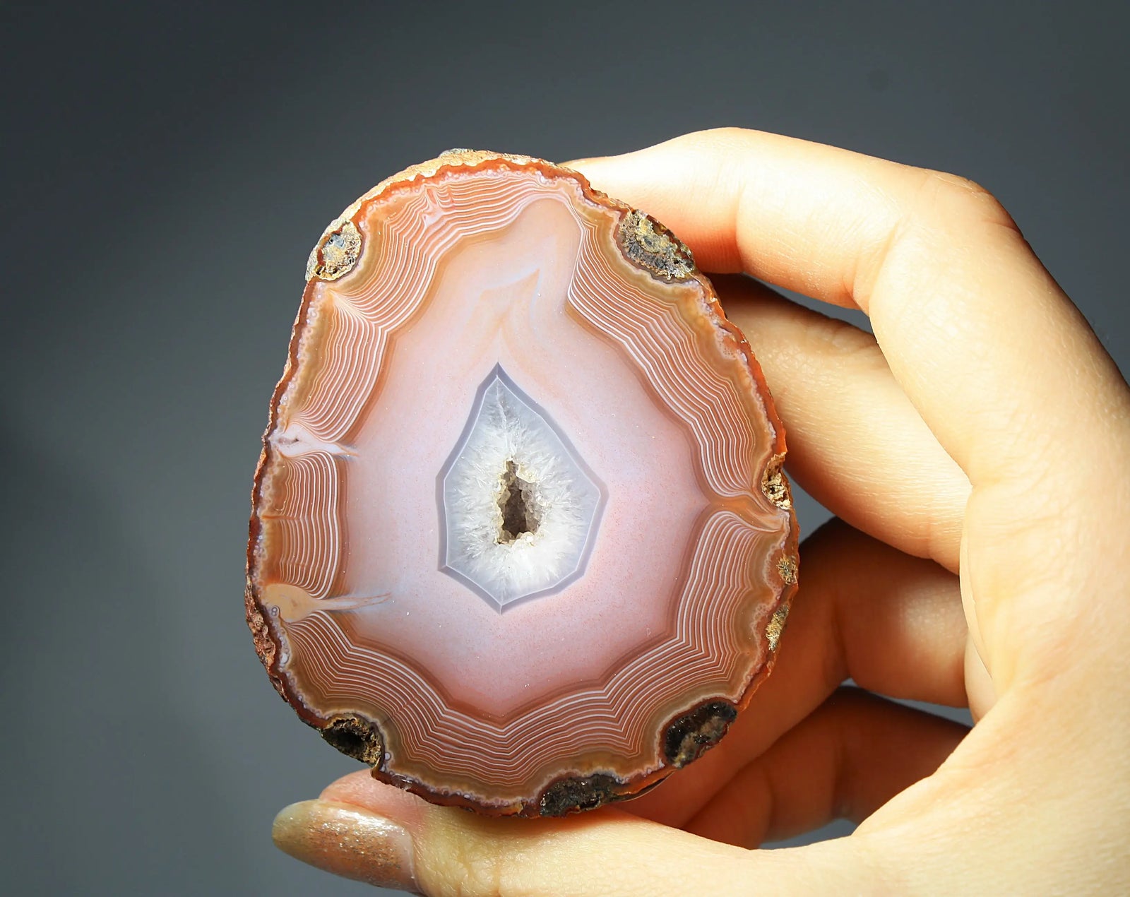 Large pink Zhanguo agate featuring natural banded patterns and a smooth polished finish