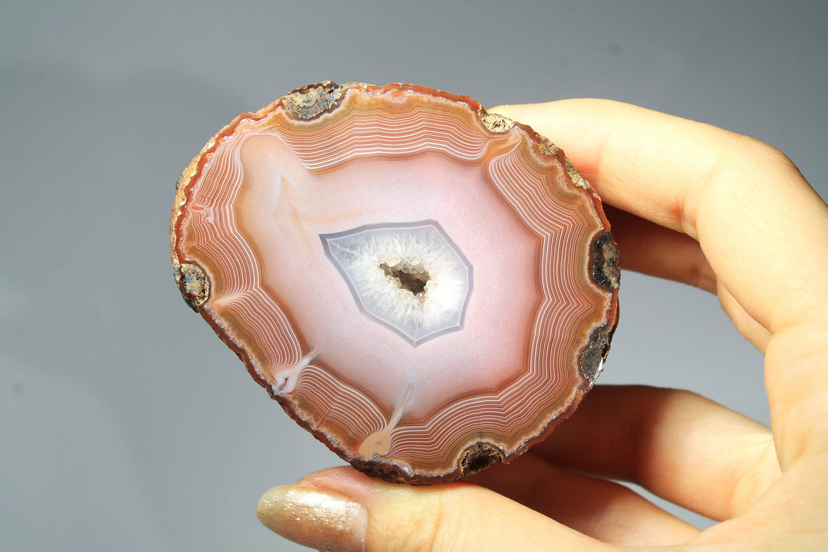 Large pink Zhanguo agate featuring natural banded patterns and a smooth polished finish