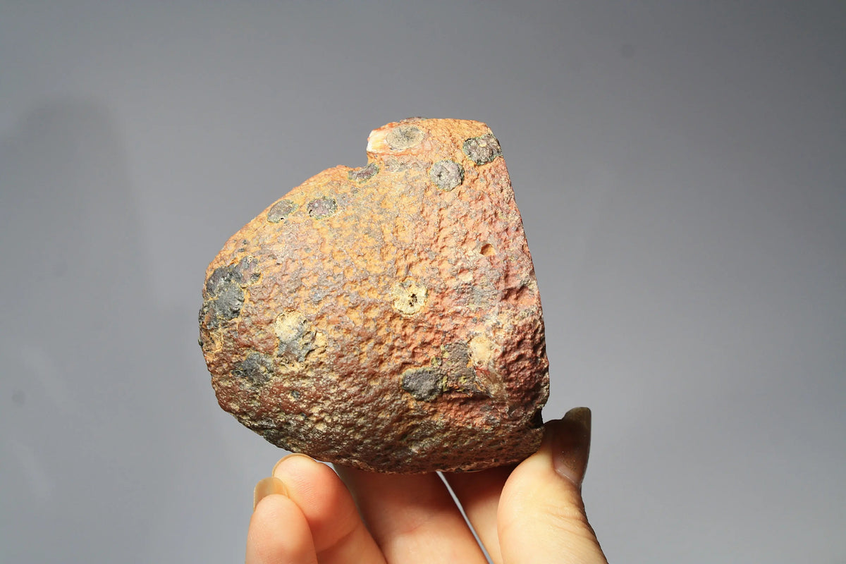 Large pink Zhanguo agate featuring natural banded patterns and a smooth polished finish
