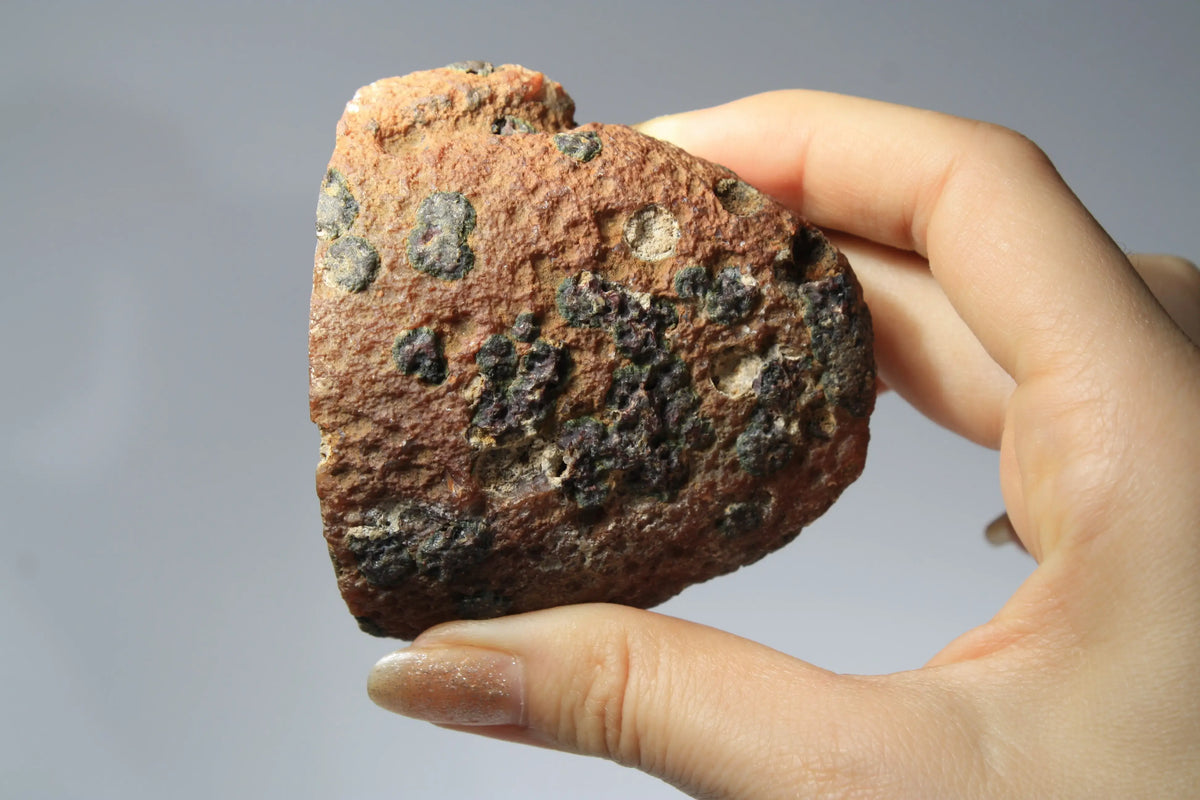 Large pink Zhanguo agate featuring natural banded patterns and a smooth polished finish