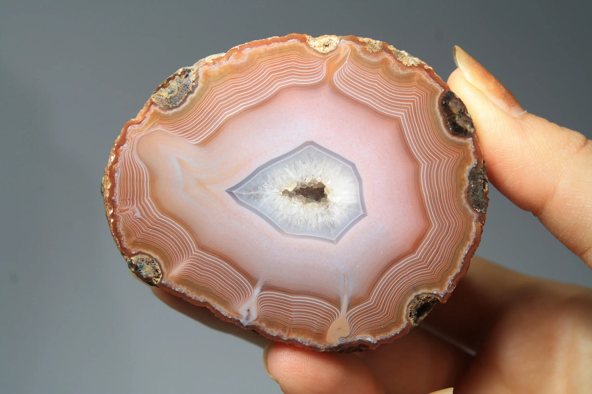 Large pink Zhanguo agate featuring natural banded patterns and a smooth polished finish