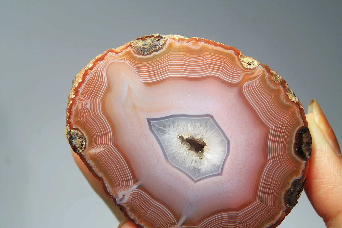 Large pink Zhanguo agate featuring natural banded patterns and a smooth polished finish