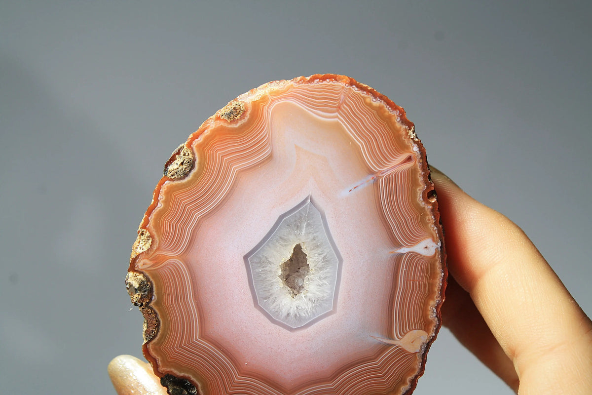 Large pink Zhanguo agate featuring natural banded patterns and a smooth polished finish