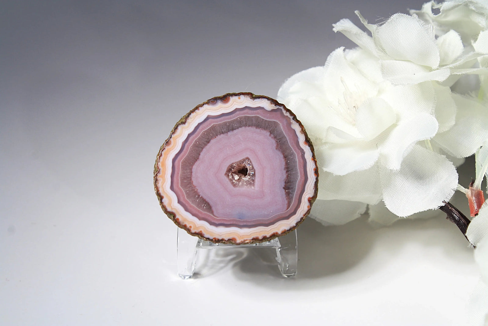 Polished purple and pink Zhanguo agate displaying vibrant color layers and organic patterns