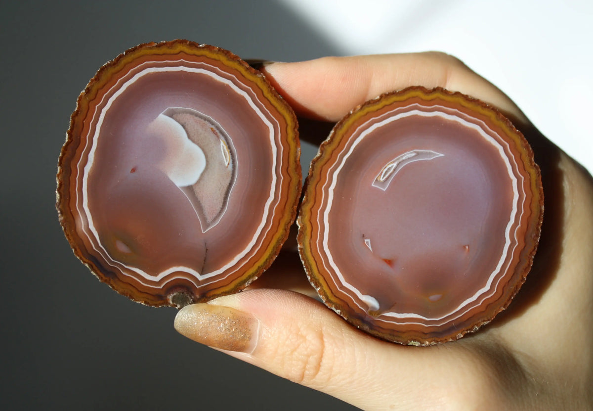 Vibrant banded Zhanguo agate pair with bold, flowing layers