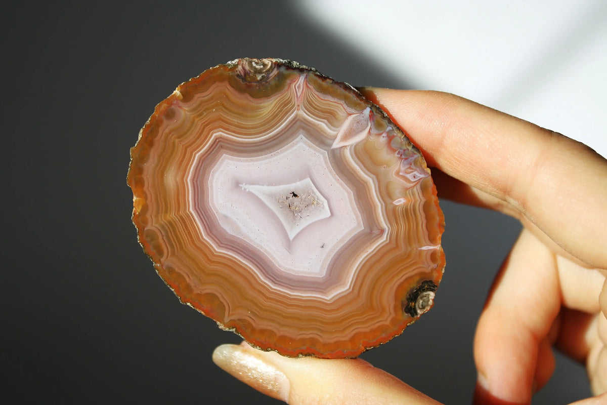 Vibrant Zhanguo agate with bold, swirling bands of crimson, gold, and jade, glowing with depth