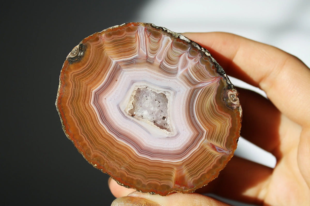 Vibrant Zhanguo agate with bold, swirling bands of crimson, gold, and jade, glowing with depth