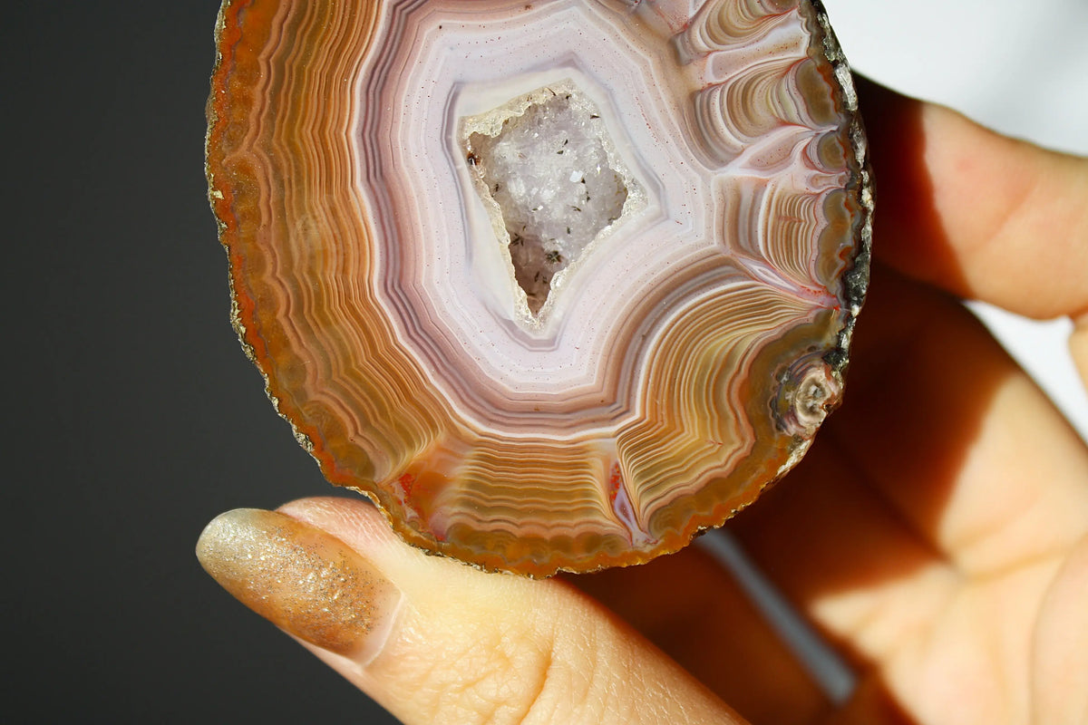 Vibrant Zhanguo agate with bold, swirling bands of crimson, gold, and jade, glowing with depth