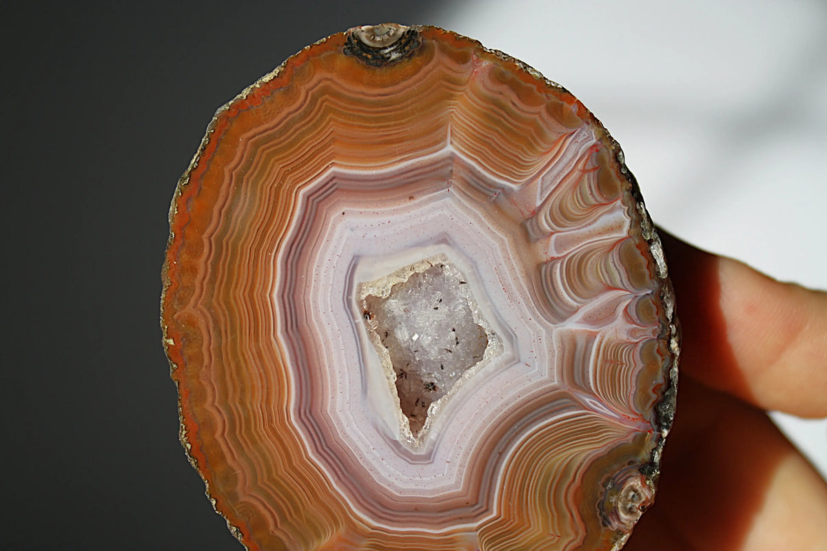 Vibrant Zhanguo agate with bold, swirling bands of crimson, gold, and jade, glowing with depth