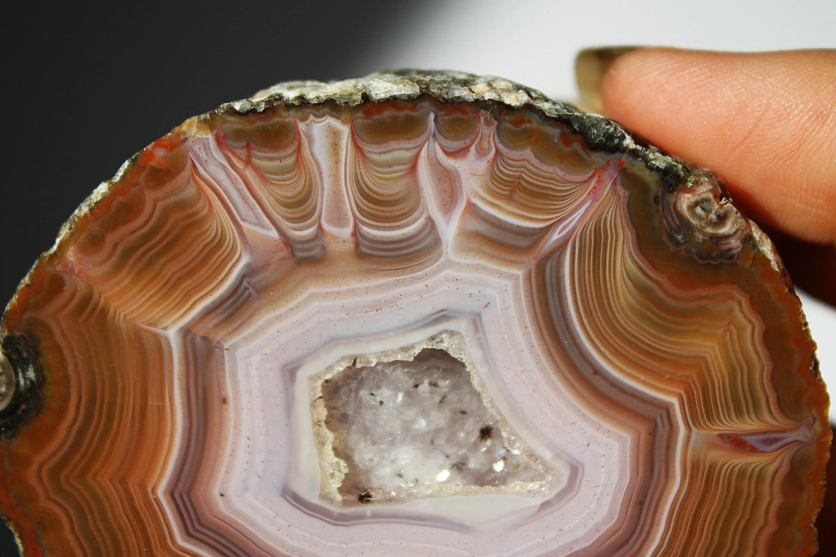 Vibrant Zhanguo agate with bold, swirling bands of crimson, gold, and jade, glowing with depth