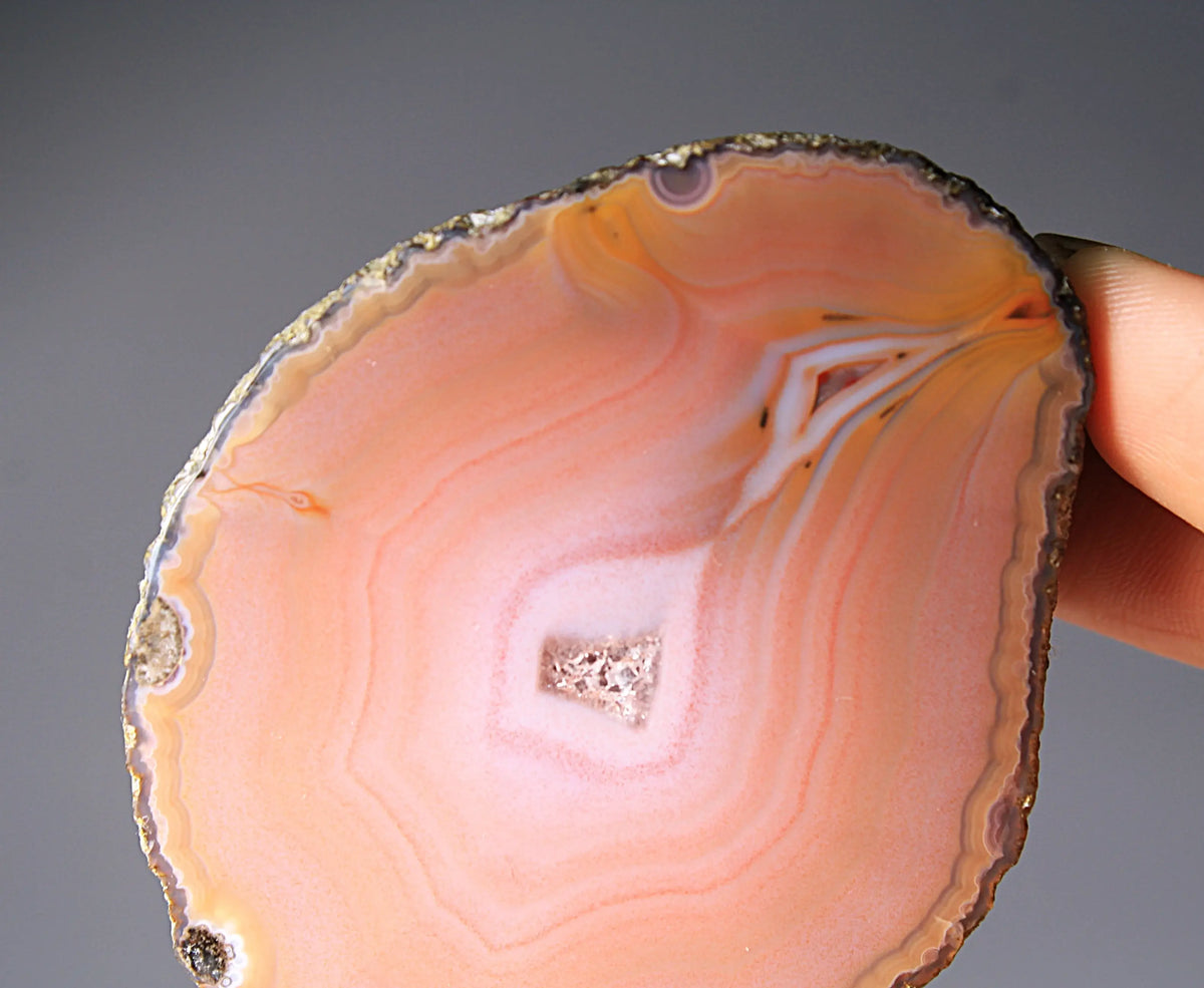 Soft pink banded Zhanguo agate pair glowing with warm, luminous tones