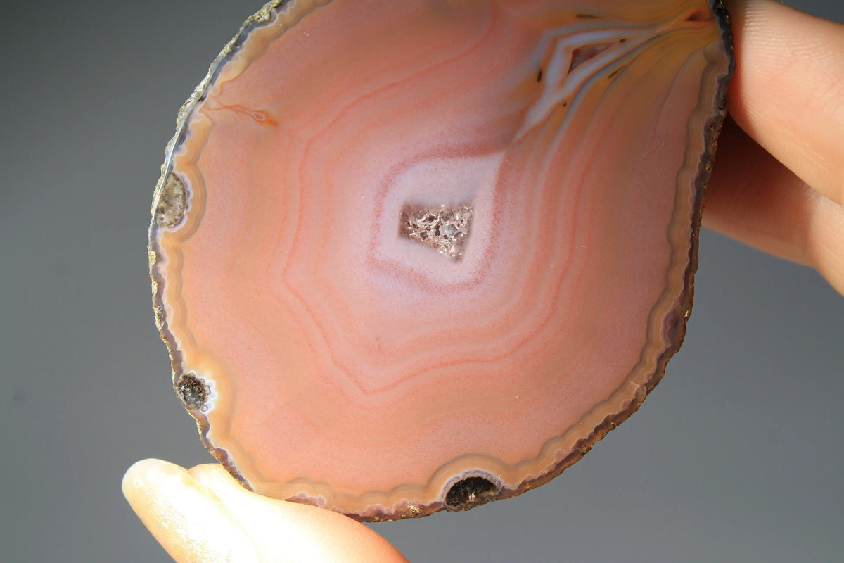 Soft pink banded Zhanguo agate pair glowing with warm, luminous tones