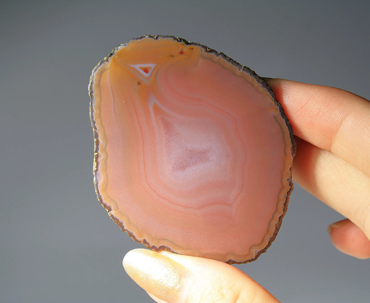 Soft pink banded Zhanguo agate pair glowing with warm, luminous tones