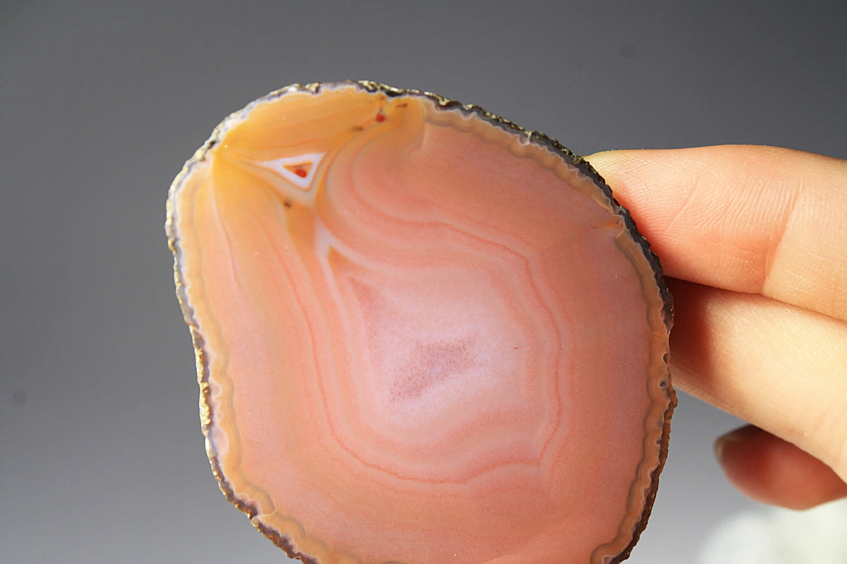 Soft pink banded Zhanguo agate pair glowing with warm, luminous tones