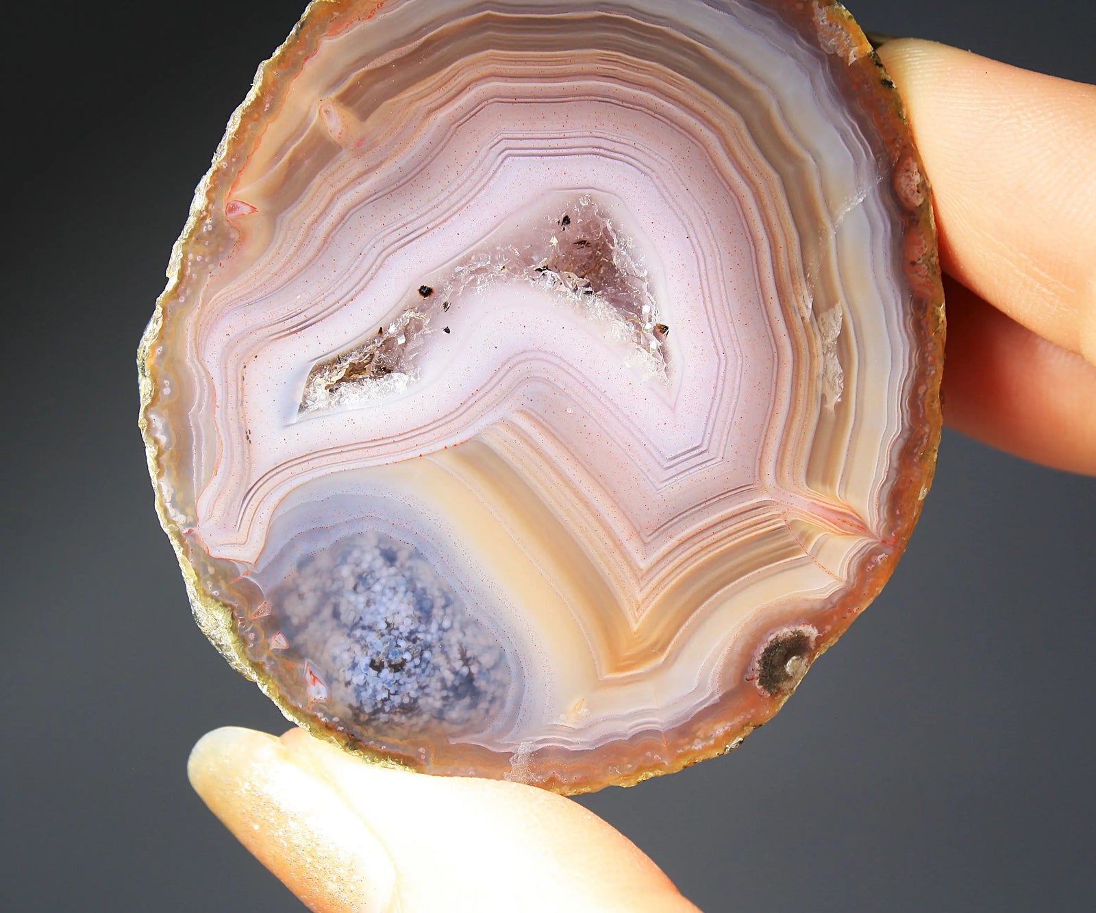 Vibrant Zhanguo agate pair with blue bands swirling among crimson, gold, and jade tones