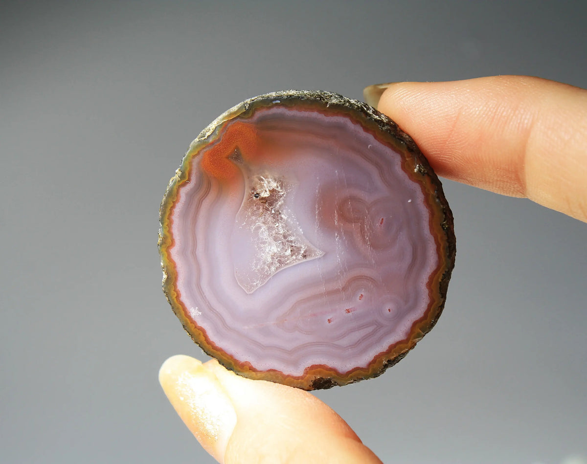 Banded purple Zhanguo agate pair with vivid swirling layers
