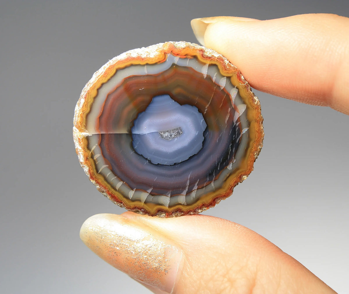 Banded purple-blue and orange Zhanguo agate pair with vivid swirling layers