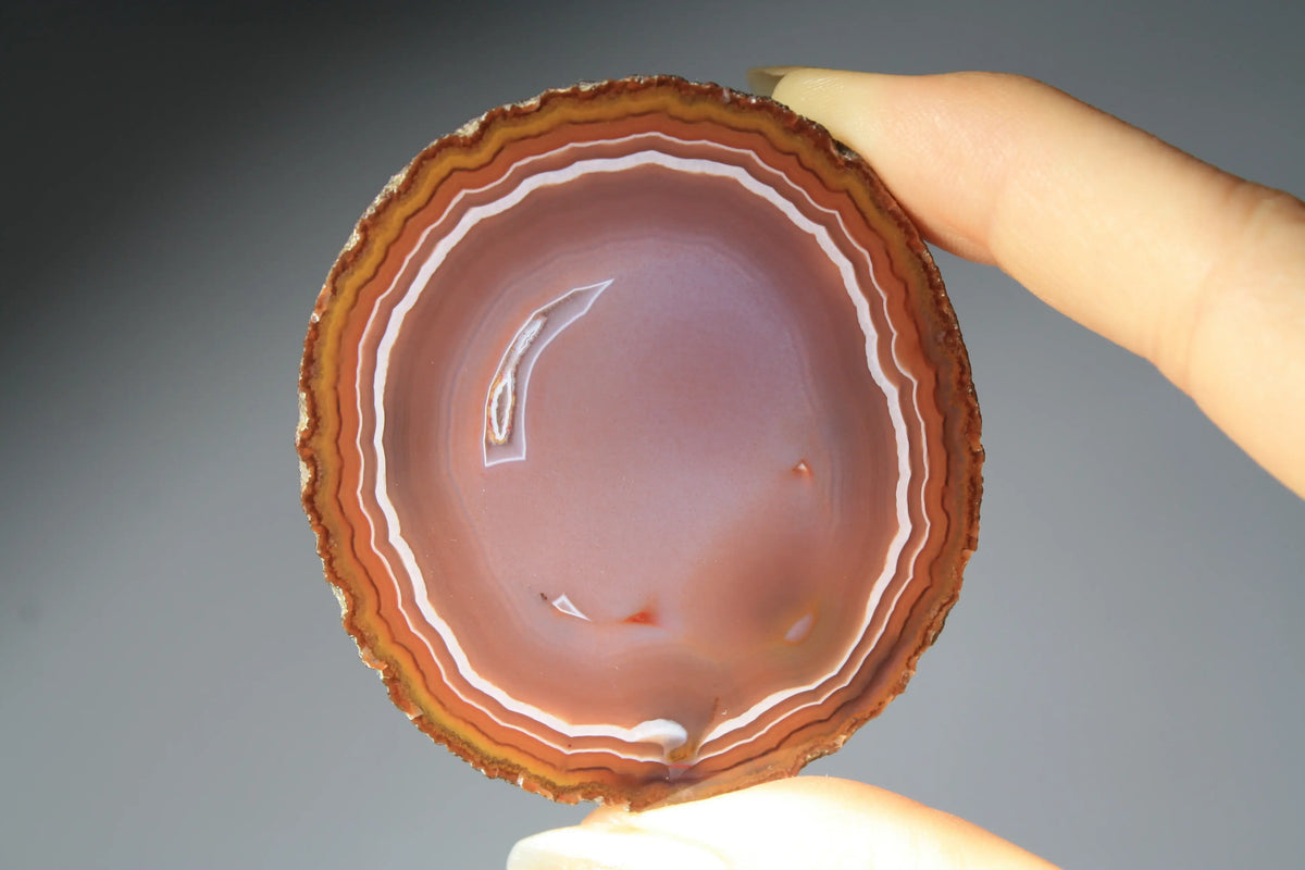 Vibrant banded Zhanguo agate pair with bold, flowing layers