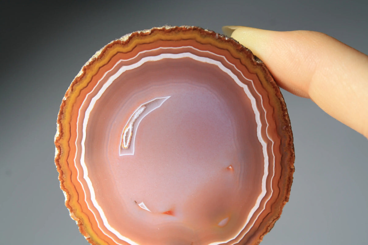 Vibrant banded Zhanguo agate pair with bold, flowing layers