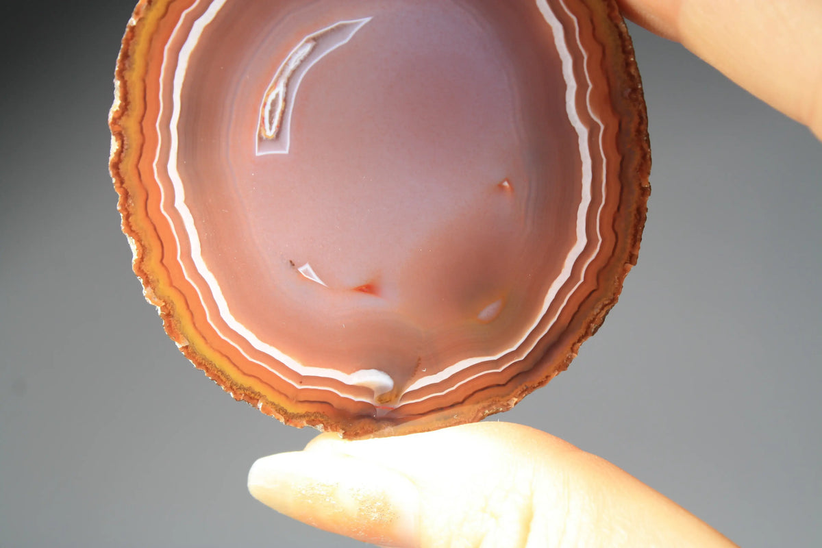 Vibrant banded Zhanguo agate pair with bold, flowing layers