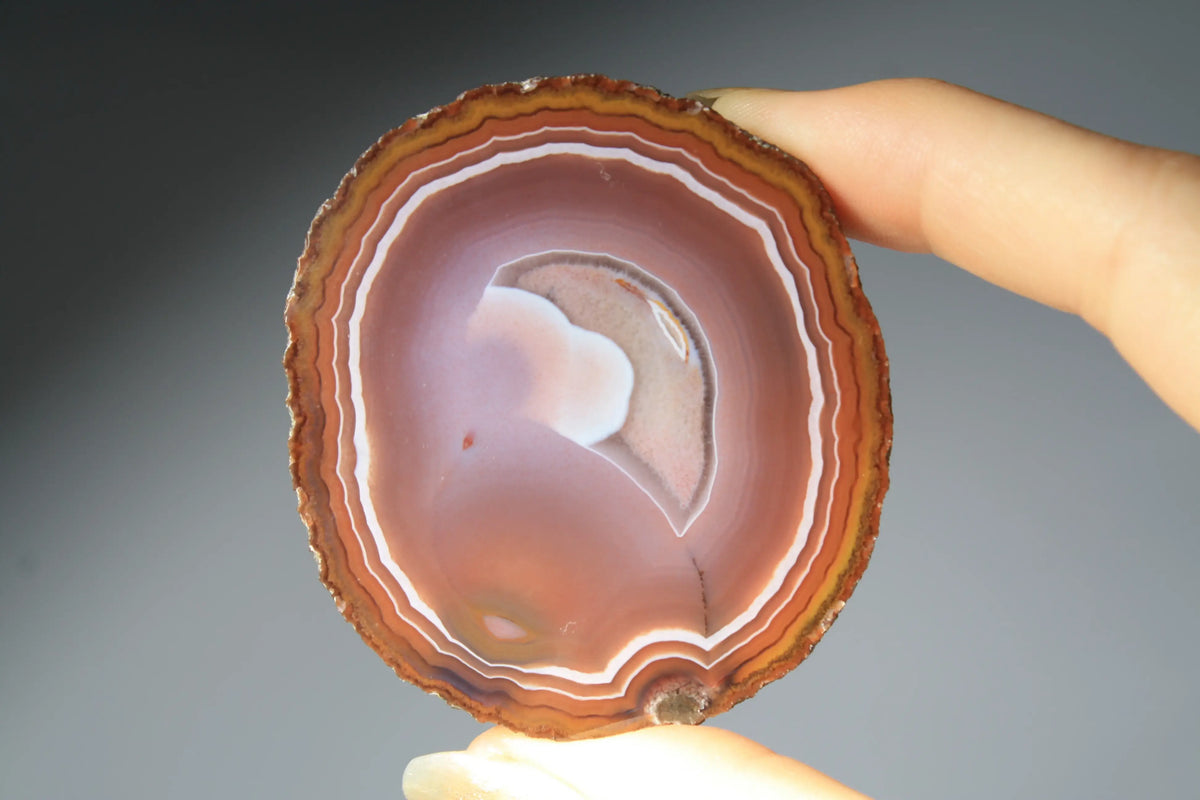 Vibrant banded Zhanguo agate pair with bold, flowing layers