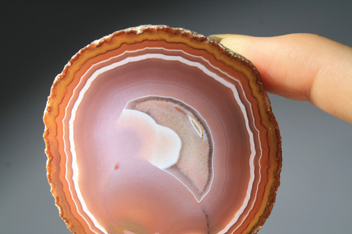 Vibrant banded Zhanguo agate pair with bold, flowing layers