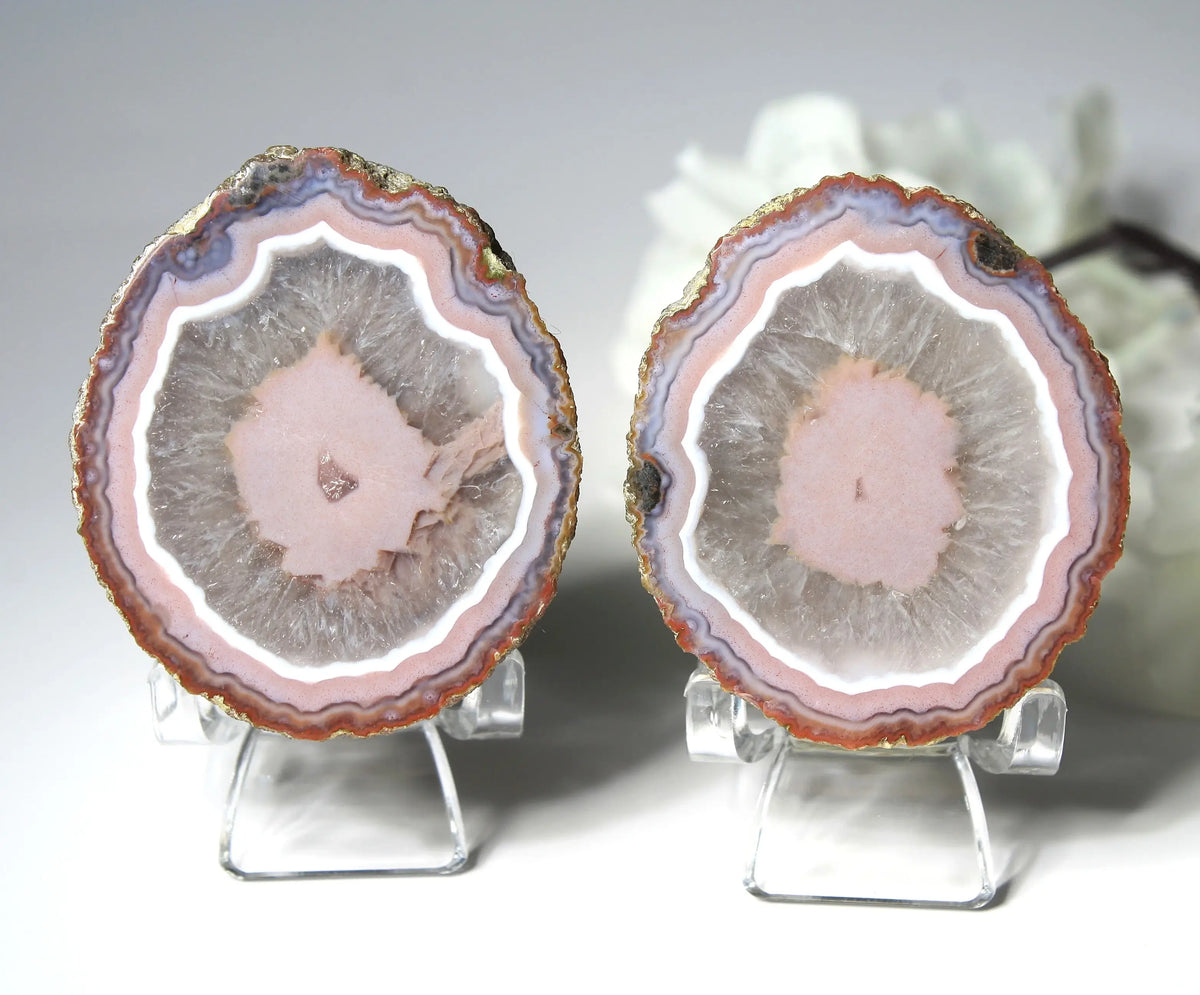 Vibrant pink Zhanguo agate pair with luminous, swirling bands