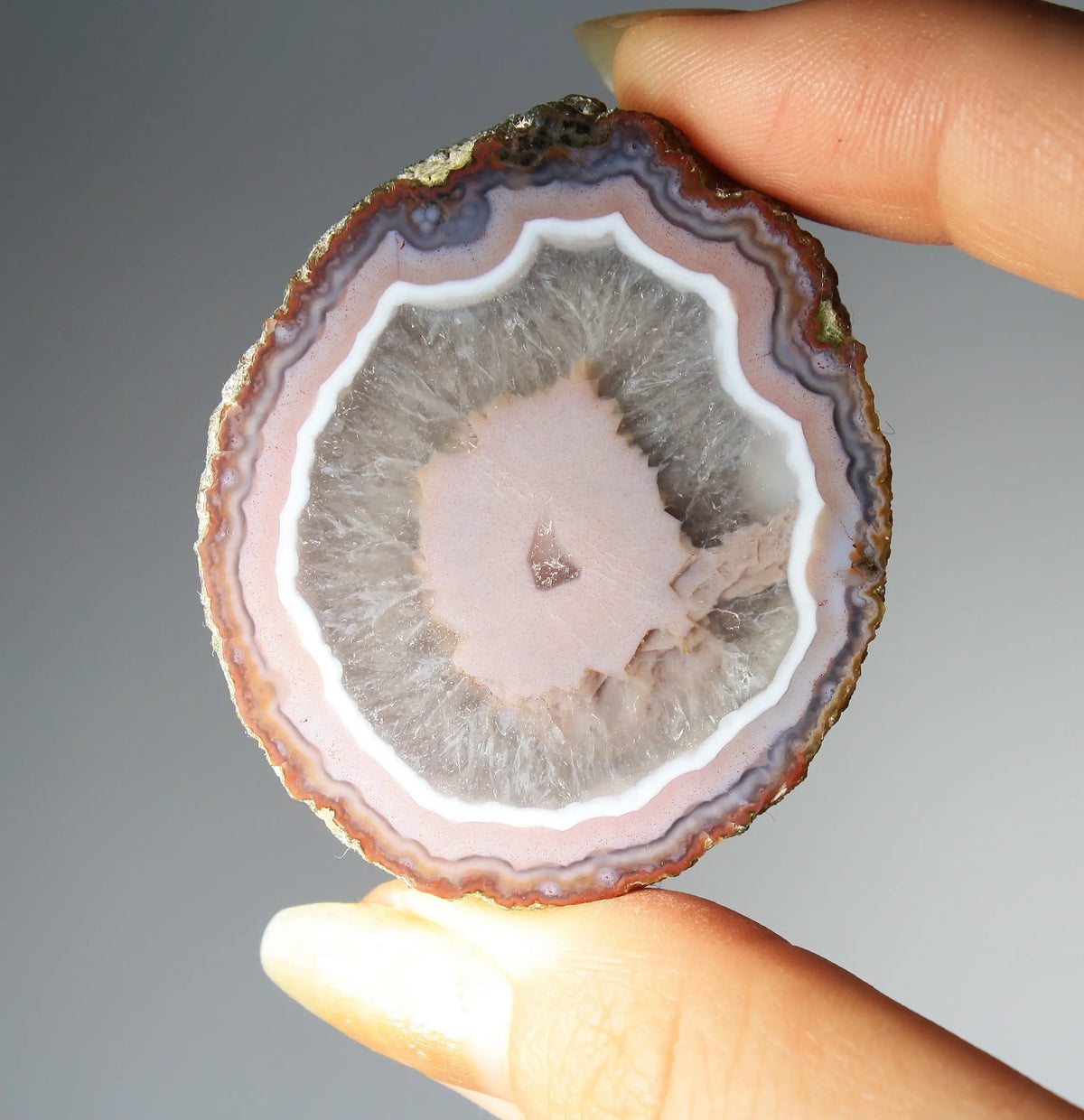 Vibrant pink Zhanguo agate pair with luminous, swirling bands