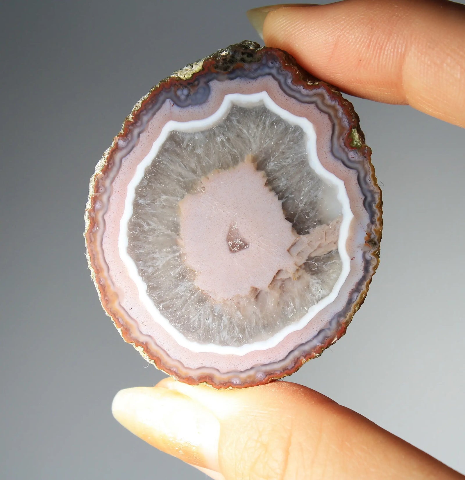 Vibrant pink Zhanguo agate pair with luminous, swirling bands