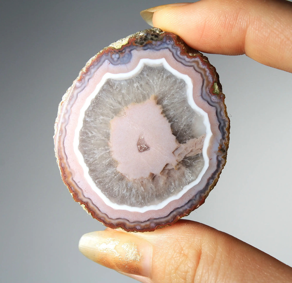 Vibrant pink Zhanguo agate pair with luminous, swirling bands