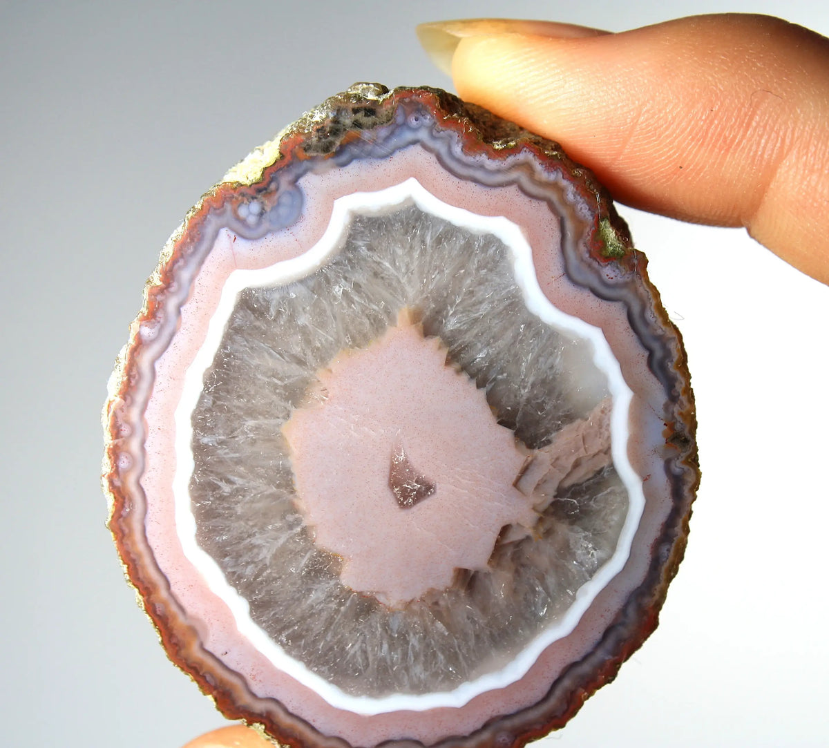 Vibrant pink Zhanguo agate pair with luminous, swirling bands