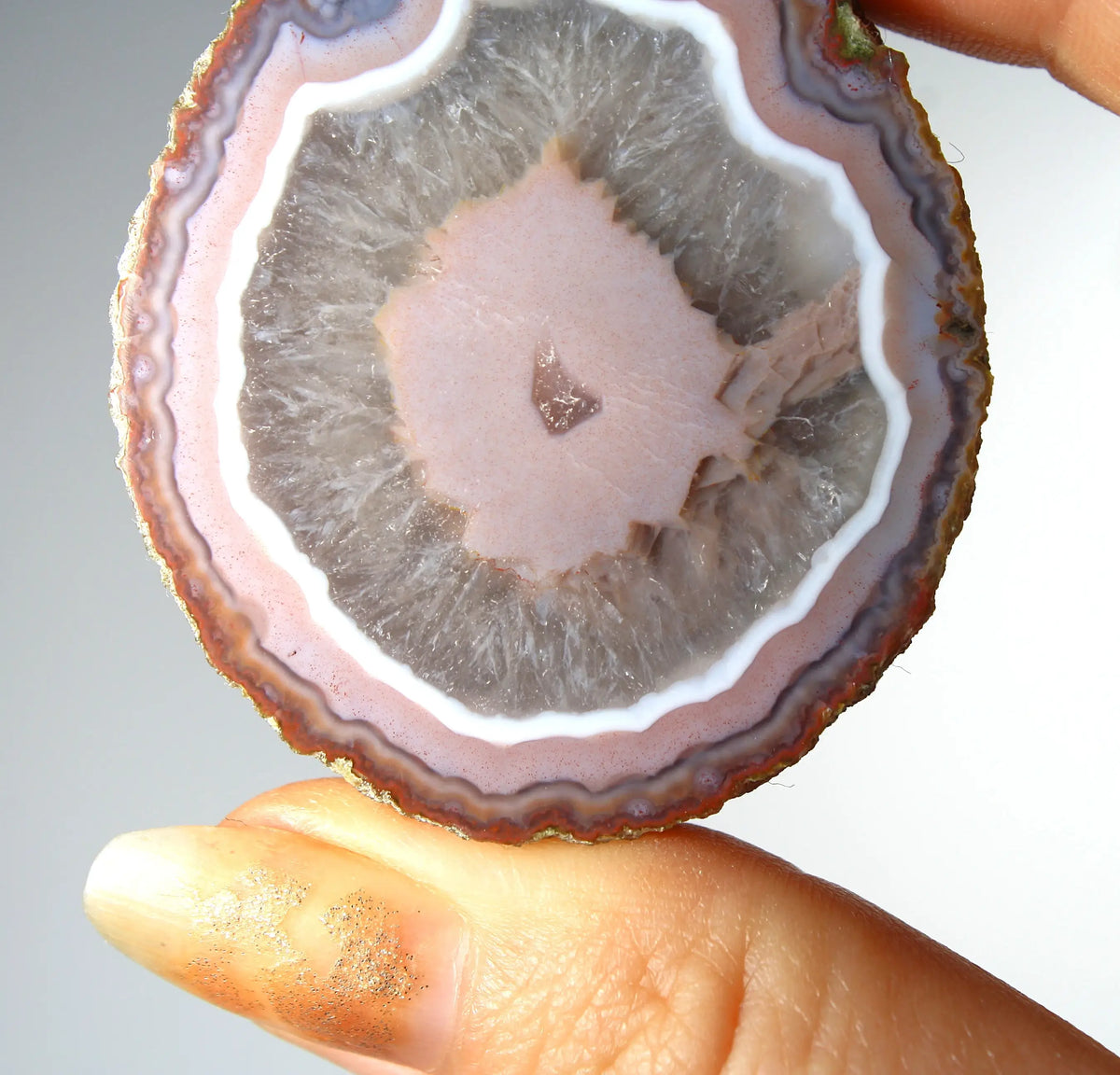 Vibrant pink Zhanguo agate pair with luminous, swirling bands